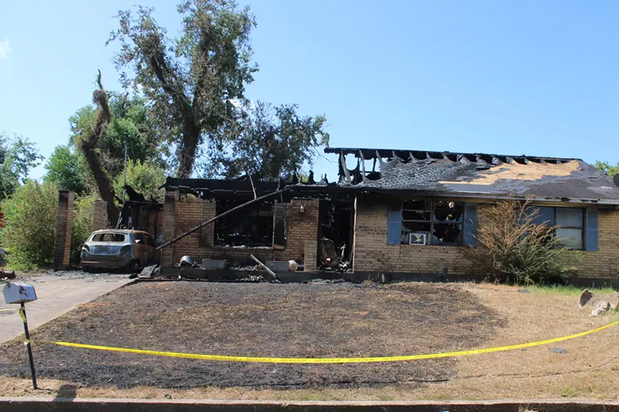 Fire investigator examining a scene for origin and cause